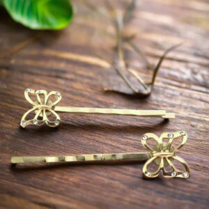 gold butterfly hair pins flatlay wood