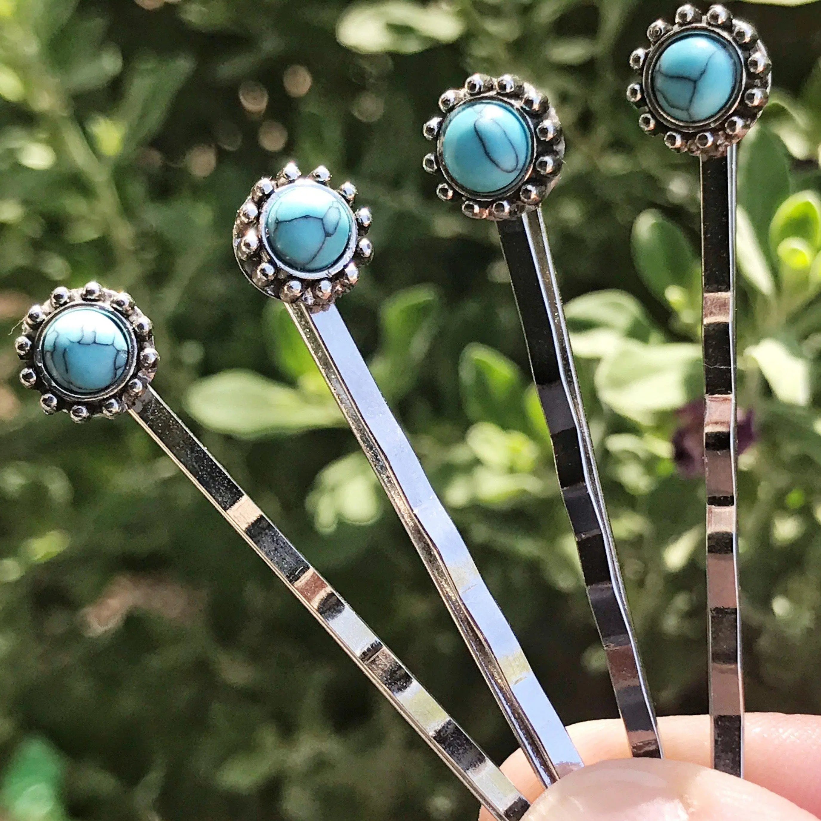 turquoise hair pins in hand turquoise hair pins in hand